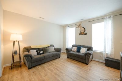 Living room with a wealth of natural light and light wood-type flooring | Image 3