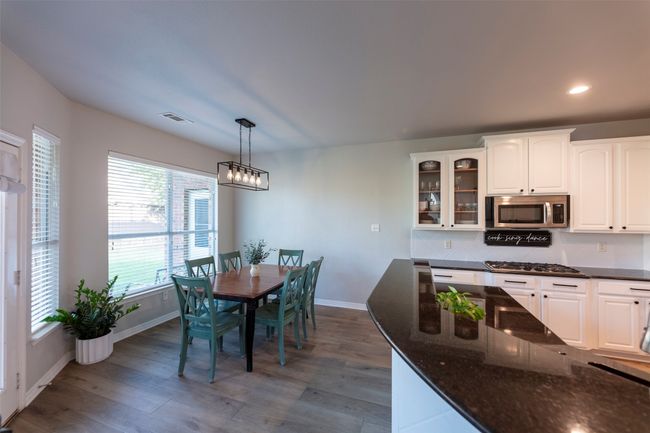 Dining area featuring wood finished floors and recessed lighting | Image 18