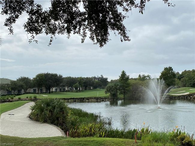 View of community featuring a water view, view of golf course, and a yard | Image 26