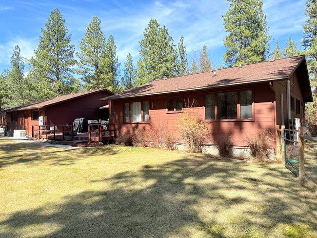 Rear view of house with a lawn and roof with shingles | Image 52
