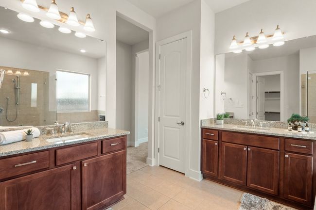 Full bathroom with two vanities, a shower stall, tile patterned flooring, and a sink | Image 16