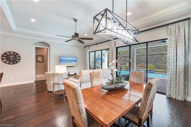 Dining space with ceiling fan, baseboards, wood finished floors, recessed lighting, and arched walkways | Image 14