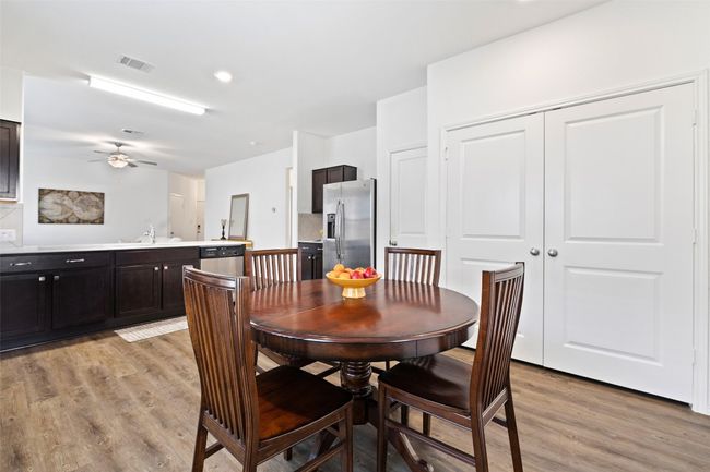 Dining space featuring light wood-style flooring and a ceiling fan | Image 15