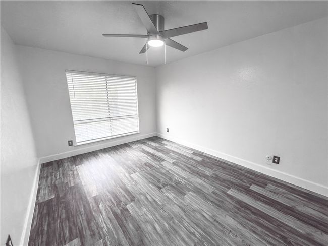 Spare room with ceiling fan and dark wood-type flooring | Image 9