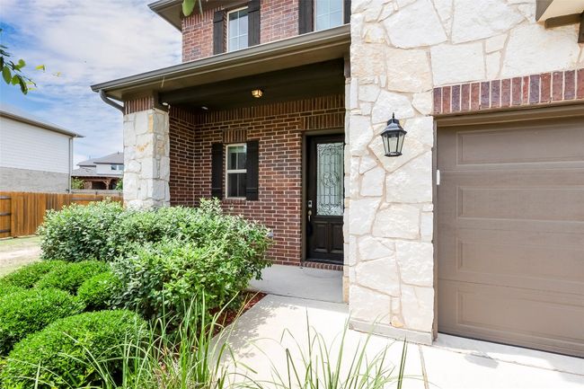 Doorway to property featuring stone siding and brick siding | Image 4