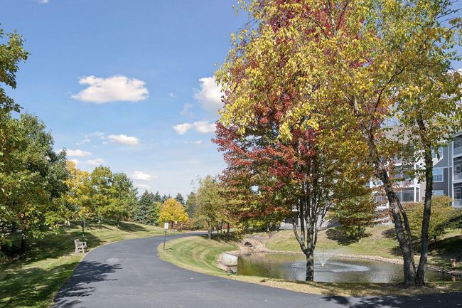 Enjoy the beautifully landscaped grounds with two fountained ponds and take the time to stop & relax on one of many benches throughout the property. | Image 35