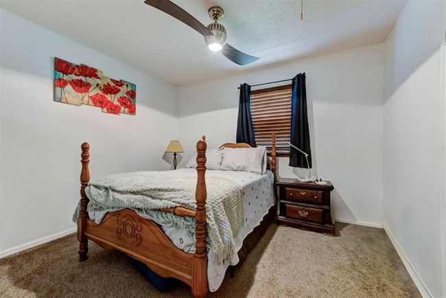 Bedroom with baseboards, a ceiling fan, and carpet flooring | Image 10