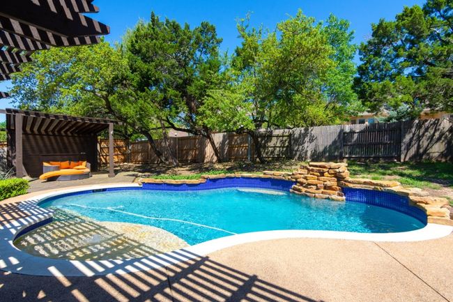 View of swimming pool with a patio area, a fenced backyard, a fenced in pool, and a pergola | Image 30