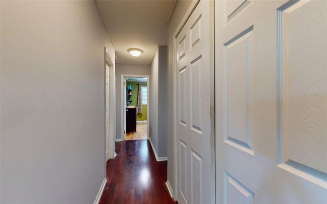 Corridor featuring dark wood-style flooring and baseboards | Image 22