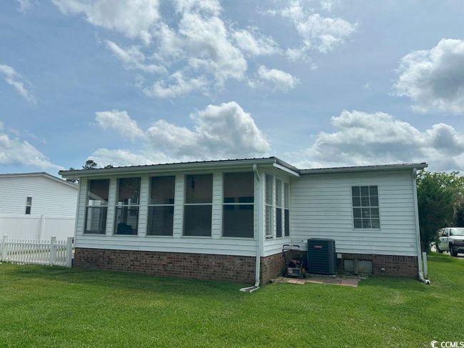 Back of house with a sunroom, central AC unit, and crawl space | Image 5
