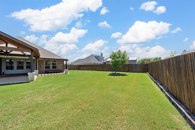 Fenced backyard featuring a patio area | Image 35