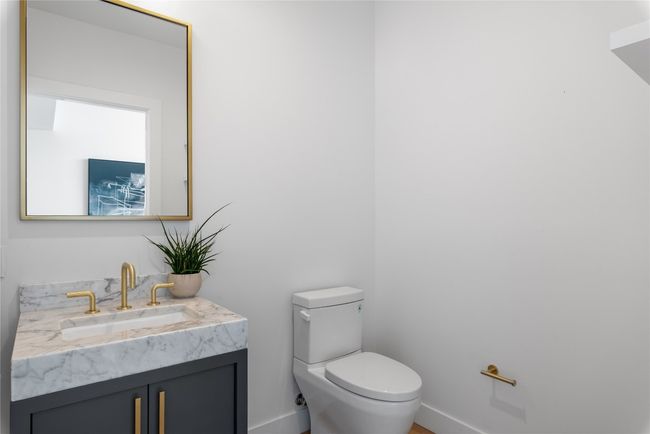 Bathroom featuring vanity, toilet, and baseboards | Image 23