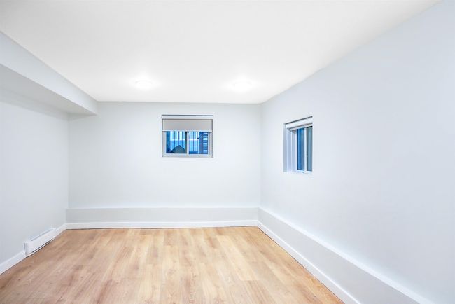 Spare room featuring baseboards, baseboard heating, and light wood-type flooring | Image 15
