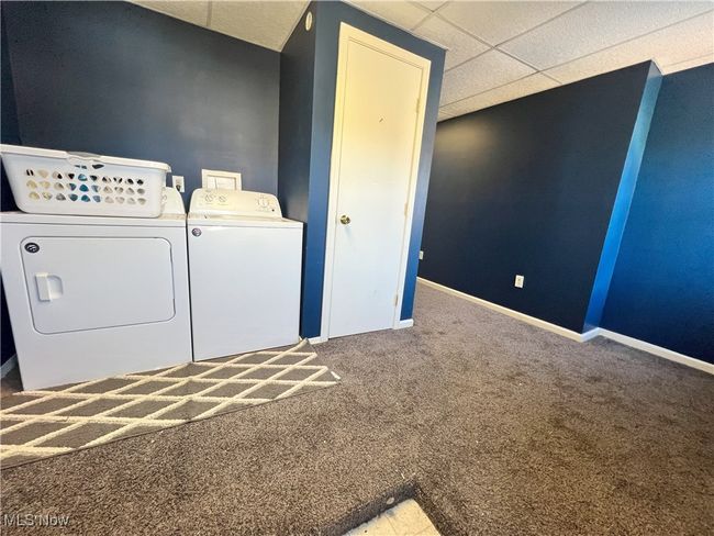 Laundry room with washing machine and dryer, baseboards, carpet, and laundry area | Image 30