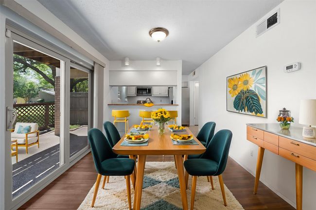 Virtually staged dining room with patio and view of greenbelt through enormous windows. All windows recently replaced. | Image 8