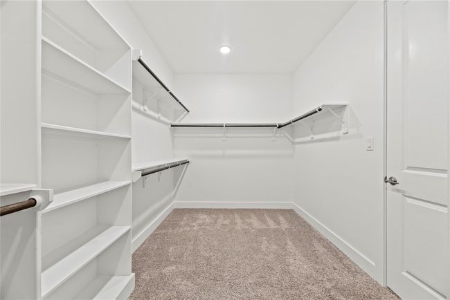 Shop until you drop! This massive walk-in closet has multiple hanging bars for clothes and built-in shelving for bags, shoes, and more. | Image 33