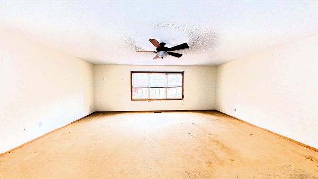 Unfurnished room with baseboards, a textured ceiling, and a ceiling fan | Image 17
