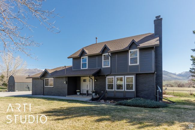 View of front of home with a chimney, brick siding, and a front yard | Image 34