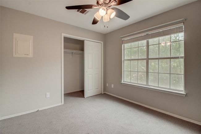 Unfurnished bedroom with carpet floors, baseboards, a closet, and a ceiling fan | Image 21