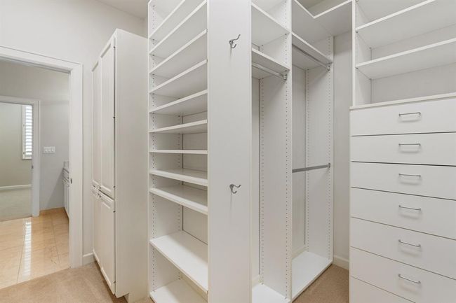 View of the closet opening to the primary bathroom. | Image 30