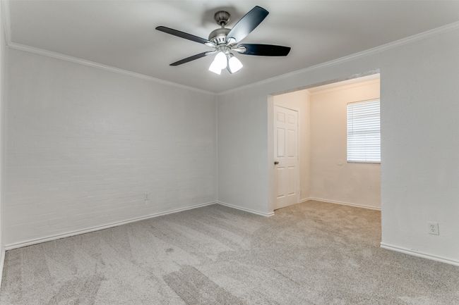 Spare room with ceiling fan, baseboards, crown molding, and carpet | Image 22
