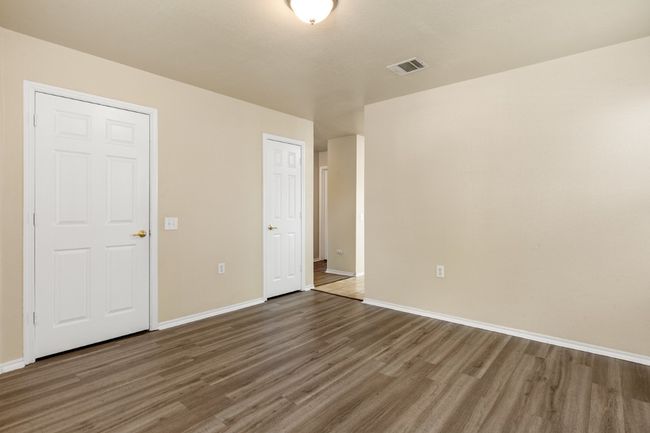 Unfurnished bedroom featuring wood finished floors and baseboards | Image 6