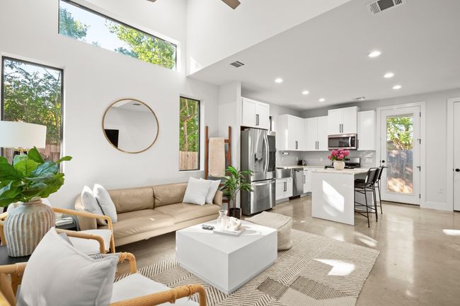 Living room with concrete floors, recessed lighting, a high ceiling, and a ceiling fan | Image 8