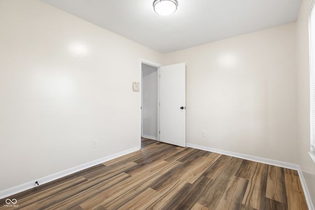 empty room with dark wood-style flooring and baseboards | Image 10