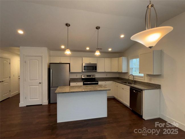 Kitchen has a great layout and quite a lot of storage. Pantry closet on the left. | Image 6