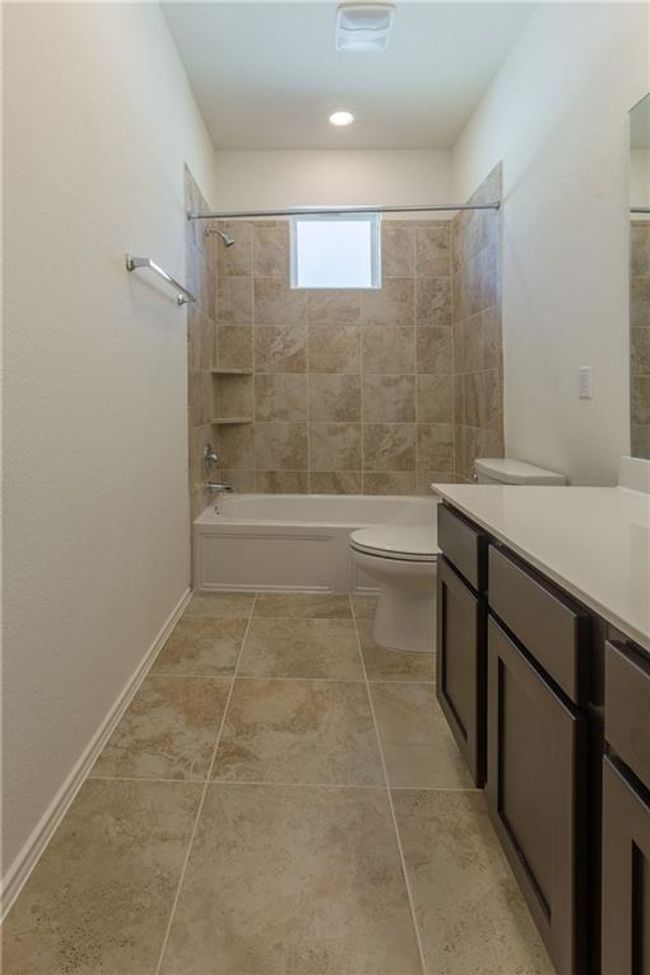 Full bath with vanity, shower / washtub combination, and tile patterned floors | Image 25