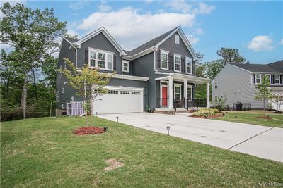 View of front of home with a garage, covered porch, and a front yard | Image 3