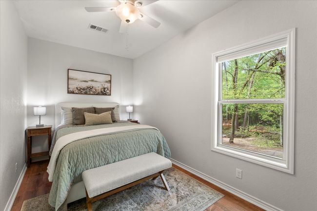 Bedroom featuring baseboards, wood finished floors, visible vents, and a ceiling fan | Image 33