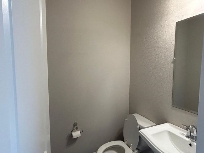 Bathroom featuring toilet and a sink | Image 14