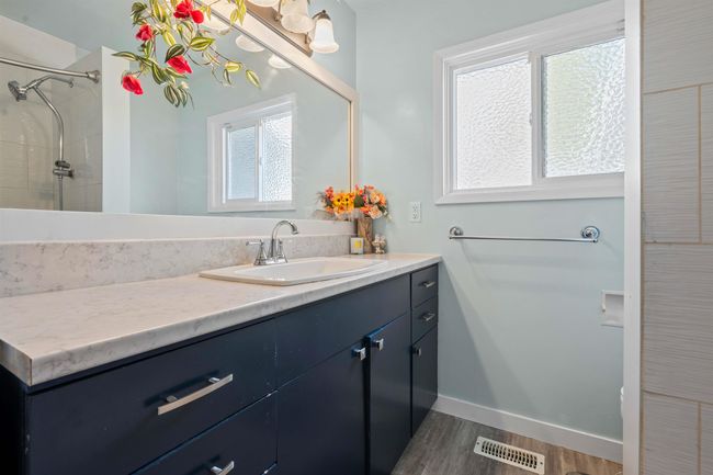 Bathroom with vanity, wood finished floors, and visible vents | Image 9