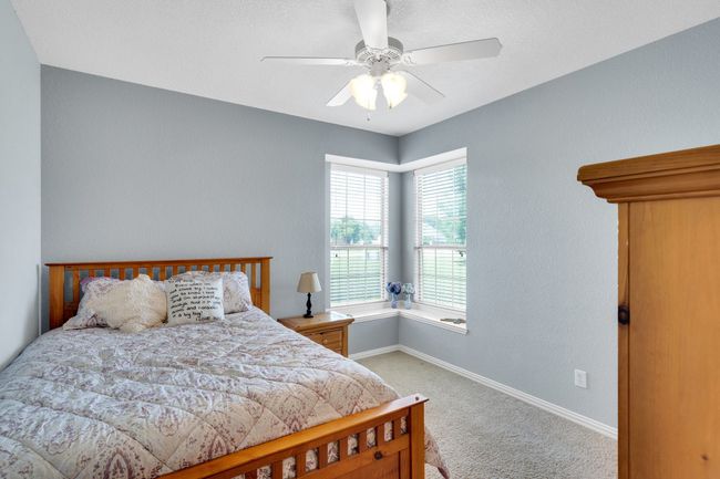Bedroom featuring carpet floors, baseboards, and a ceiling fan | Image 16