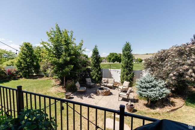 Fenced backyard with an outdoor fire pit and a patio area | Image 44