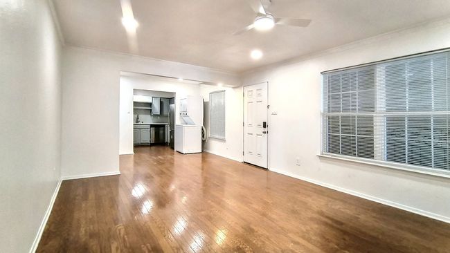 Unfurnished living room featuring crown molding, ceiling fan, and dark hardwood / wood-style flooring | Image 5