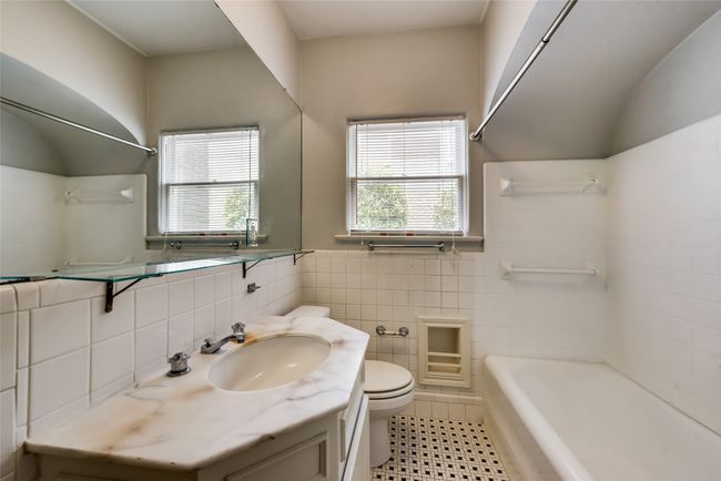 Bathroom with vanity, tile walls, shower / bath combination, and a wainscoted wall | Image 18