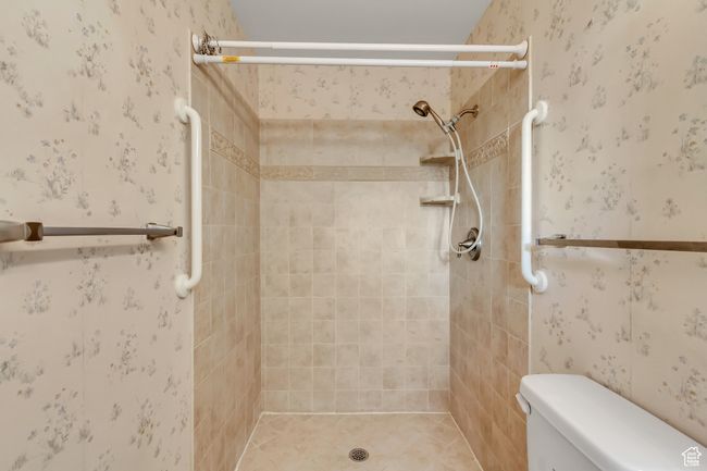 Full bath with wallpapered walls, a shower stall, and toilet | Image 14