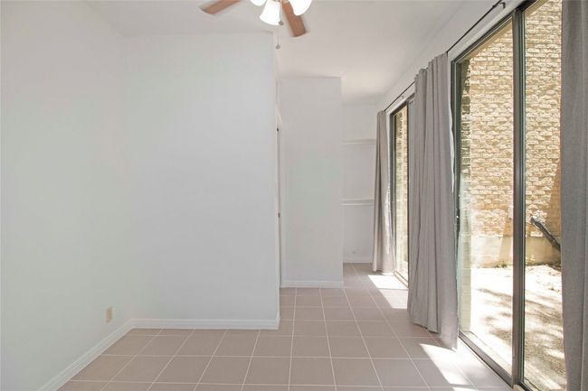 Downstairs room with Sliding doors to another Private Courtyard. | Image 24