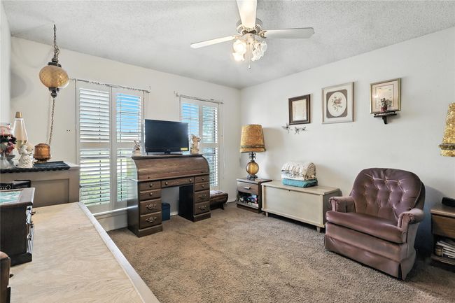 Living area featuring a ceiling fan, a textured ceiling, and carpet floors | Image 28