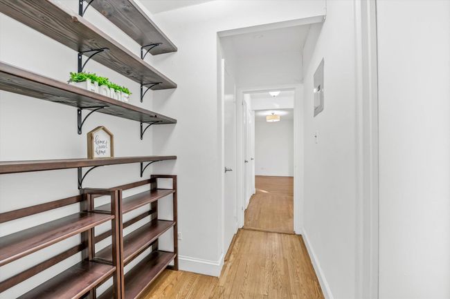 Corridor featuring light wood finished floors and baseboards | Image 11