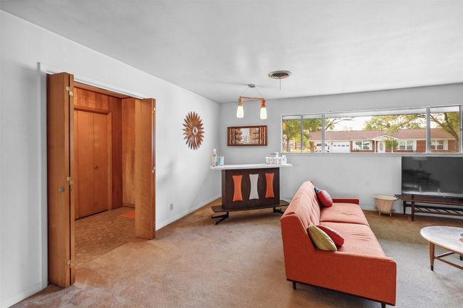 Carpeted living room with baseboards | Image 14