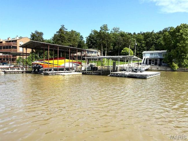 Dock area with a water view and boat lift | Image 9