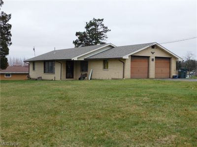 Single story home featuring a front lawn and a garage | Image 3