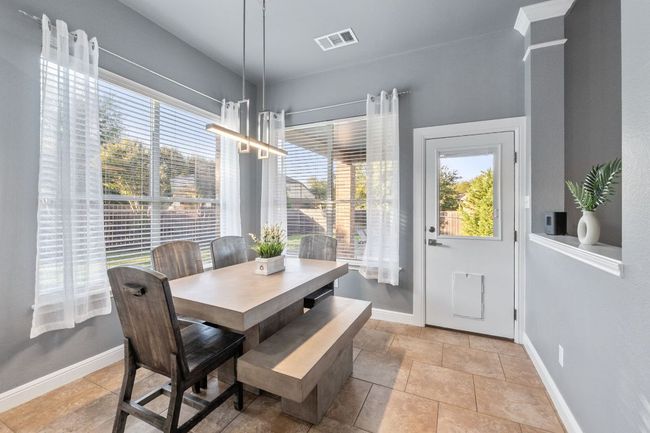 Really light and bright breakfast area overlooking the back yard and pool. | Image 8