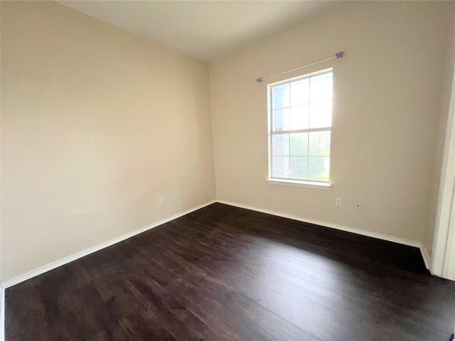 Spare room with dark wood finished floors and baseboards | Image 6