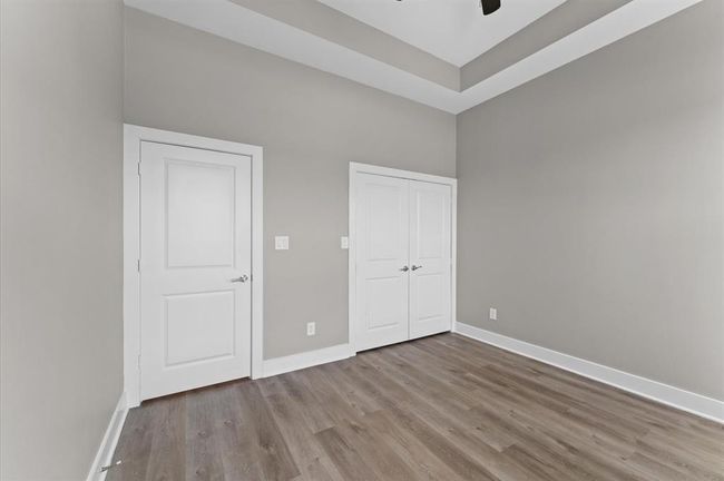 Forth bedroom with modern finishes and no carpet. | Image 24