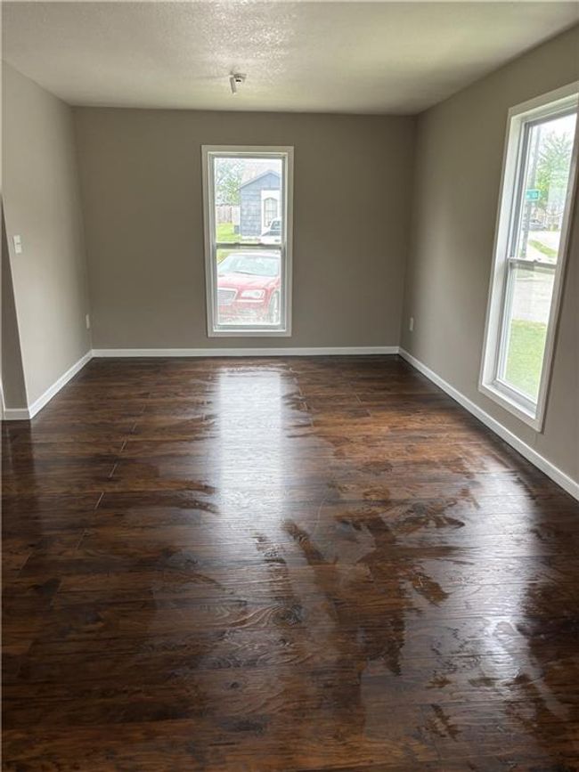 Spare room with dark wood-style flooring, baseboards, and a healthy amount of sunlight | Image 28