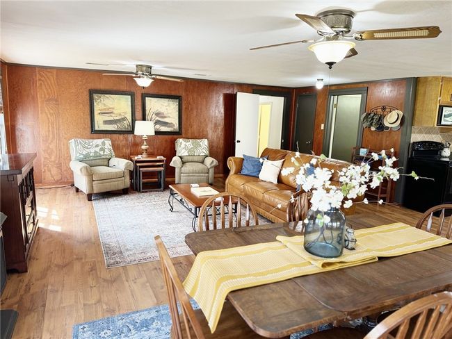 Dining area featuring light wood finished floors and ceiling fan | Image 10